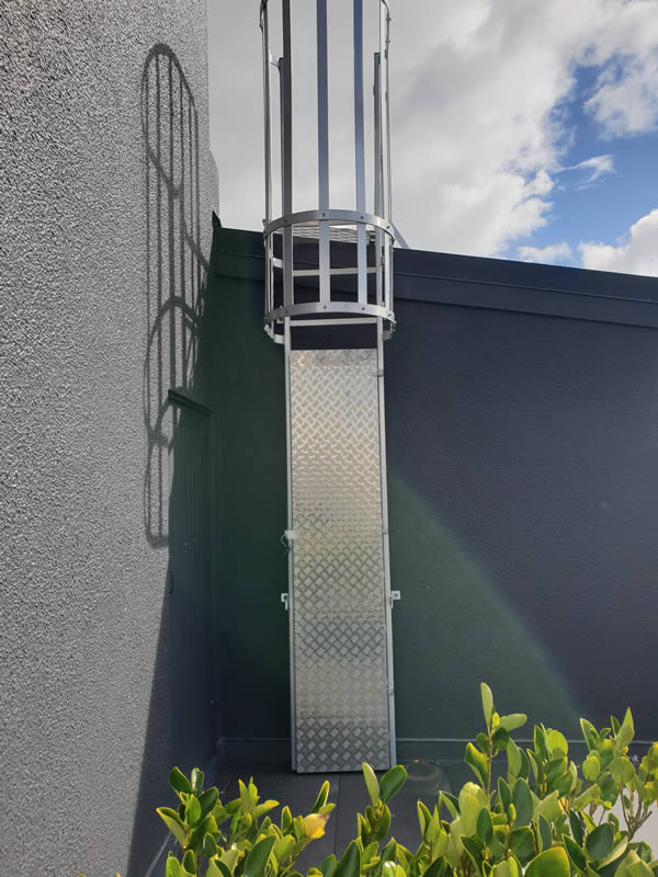 Fixed cage ladder with lockable flap